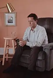 Man Sitting in Chair (2018)